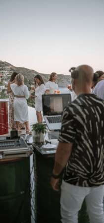 Dj plays music in a seaside villa party in Crete