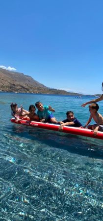 Group of children enjoy the sea on a kayak in Cretan sea