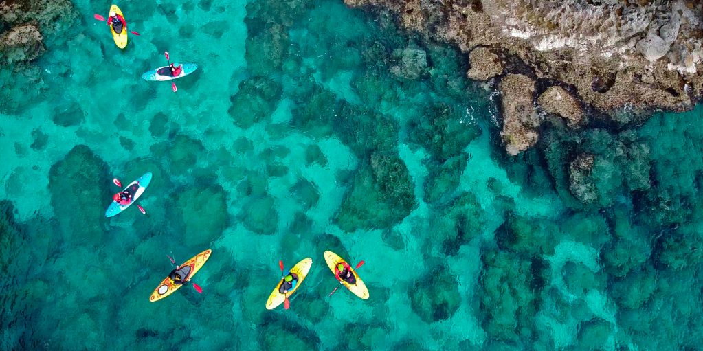 Sea kayaking in blue green waters in the Aegean Sea