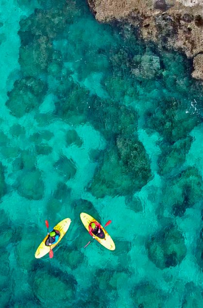 Sea kayaking in blue green waters in the Aegean Sea