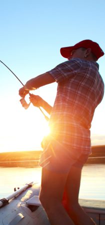 Man fishing while sailing in Crete