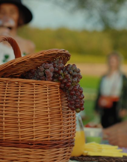 Ripe Red Grapes In Basket At Dinner table