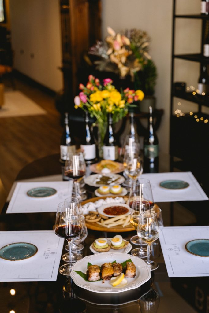 Table full with wine and food during wine tasting in Heraklion